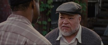 Movie still from “Fences” (2016), directed by Denzel Washington – An older man wearing a hat talking to a younger man; Close Up shot, Over the shoulder angle