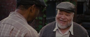 Movie still from “Fences” (2016), directed by Denzel Washington – Two men talking to each other outside in the day; Close Up shot, Over the shoulder angle