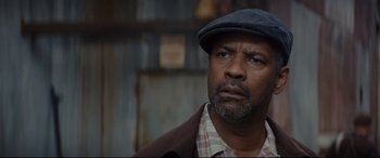 Movie still from “Fences” (2016), directed by Denzel Washington – An older man wearing a hat and a plaid shirt; Close Up shot, Low angle