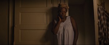 Movie still from “Fences” (2016), directed by Denzel Washington – A woman in a white dress and a head wrap; Medium shot, Low angle
