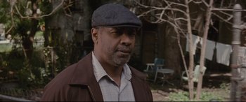Movie still from “Fences” (2016), directed by Denzel Washington – A man wearing a hat and a brown jacket; Close Up shot, Over the shoulder angle