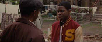 Movie still from “Fences” (2016), directed by Denzel Washington – Two men standing next to each other in a field; Close Up shot, Over the shoulder angle