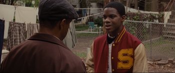 Movie still from “Fences” (2016), directed by Denzel Washington – Two young men are talking in a field; Close Up shot, Over the shoulder angle
