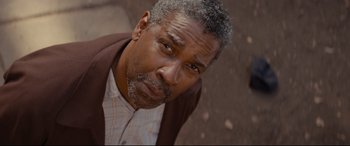 Movie still from “Fences” (2016), directed by Denzel Washington – An older black man with a beard looking at the camera; Close Up shot, High angle