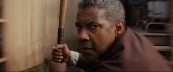 Movie still from “Fences” (2016), directed by Denzel Washington – A person holding a baseball bat; Close Up shot, Over the shoulder angle