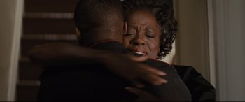 Movie still from “Fences” (2016), directed by Denzel Washington – An older woman is hugging a younger man; Close Up shot, Over the shoulder angle