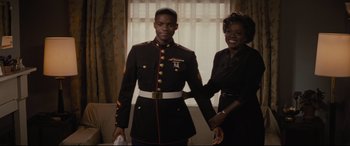 Movie still from “Fences” (2016), directed by Denzel Washington – A man and a woman holding hands in front of a window; Medium shot, Low angle