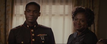 Movie still from “Fences” (2016), directed by Denzel Washington – A man and a woman standing next to each other; Close Up shot, Over the shoulder angle