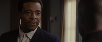 Movie still from “Fences” (2016), directed by Denzel Washington – A person wearing a suit and tie; Close Up shot, Over the shoulder angle
