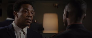 Movie still from “Fences” (2016), directed by Denzel Washington – A man in a suit talking to another man in a suit; Close Up shot, Over the shoulder angle