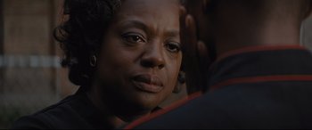 Movie still from “Fences” (2016), directed by Denzel Washington – An older black woman looking into the distance; Close Up shot, Over the shoulder angle