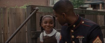 Movie still from “Fences” (2016), directed by Denzel Washington – A man and a little girl standing next to each other; Close Up shot, Over the shoulder angle