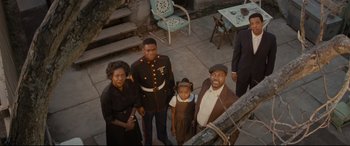 Movie still from “Fences” (2016), directed by Denzel Washington – An old photo of a man , woman , and two young children; Wide shot, High angle