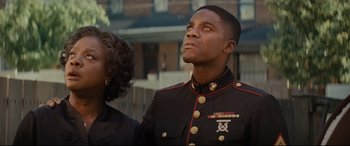 Movie still from “Fences” (2016), directed by Denzel Washington – A man in a military uniform looking up at the sky; Close Up shot, Low angle