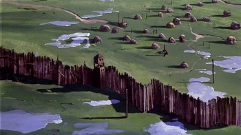 Movie still from “Fire and Ice” (1983), directed by Ralph Bakshi – An aerial view of a green field with a tower in the middle; Extreme Wide shot, High angle