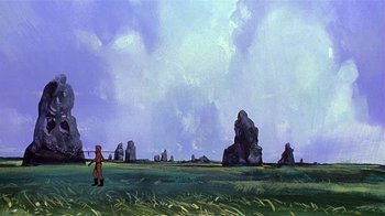 Movie still from “Fire and Ice” (1983), directed by Ralph Bakshi – A person standing in a field near a large rock formation; Extreme Wide shot, Low angle