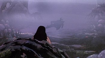 Movie still from “Fire and Ice” (1983), directed by Ralph Bakshi – A woman sitting on top of a hill looking at a dragon; Extreme Wide shot, Low angle