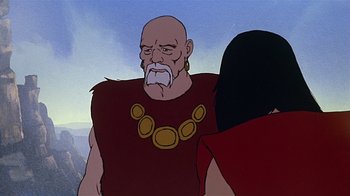 Movie still from “Fire and Ice” (1983), directed by Ralph Bakshi – An old man wearing a red shirt and a gold necklace; Medium shot, Over the shoulder angle