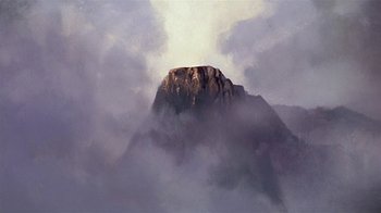 Movie still from “Fire and Ice” (1983), directed by Ralph Bakshi – A painting of a mountain in the middle of a cloud filled sky; Extreme Wide shot, Low angle