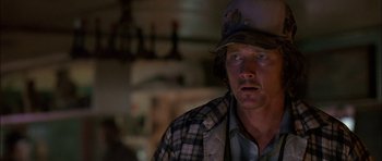 Movie still from “Fire in the Sky” (1993), directed by Robert Lieberman – A person wearing a hat; Close Up shot, Over the shoulder angle