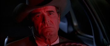 Movie still from “Fire in the Sky” (1993), directed by Robert Lieberman – An older man wearing a cowboy hat looking at the camera; Close Up shot, Low angle