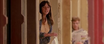 Movie still from “Fire in the Sky” (1993), directed by Robert Lieberman – A young woman standing in front of a door; Medium shot, Low angle