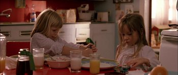 Movie still from “Fire in the Sky” (1993), directed by Robert Lieberman – Two young children sitting at a dinner table; Close Up shot, High angle