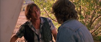 Movie still from “Fire in the Sky” (1993), directed by Robert Lieberman – Two men are talking in the woods; Close Up shot, Over the shoulder angle