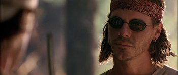 Movie still from “Fire in the Sky” (1993), directed by Robert Lieberman – A person wearing sunglasses; Close Up shot, Low angle