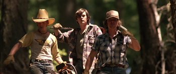 Movie still from “Fire in the Sky” (1993), directed by Robert Lieberman – A group of men standing next to each other; Medium shot, Low angle