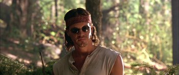 Movie still from “Fire in the Sky” (1993), directed by Robert Lieberman – A man with long brown hair wearing sunglasses and a bandana; Close Up shot, Low angle
