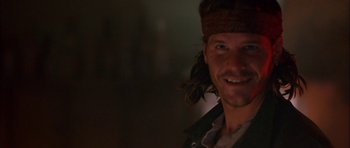 Movie still from “Fire in the Sky” (1993), directed by Robert Lieberman – A person smiling for the camera; Close Up shot, Over the shoulder angle