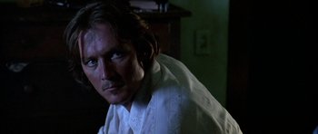 Movie still from “Fire in the Sky” (1993), directed by Robert Lieberman – A person wearing a white shirt; Close Up shot, Low angle