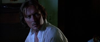 Movie still from “Fire in the Sky” (1993), directed by Robert Lieberman – A person wearing a white shirt; Close Up shot, Over the shoulder angle