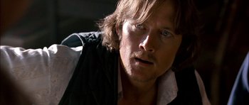 Movie still from “Fire in the Sky” (1993), directed by Robert Lieberman – A person with long brown hair; Close Up shot, Over the shoulder angle