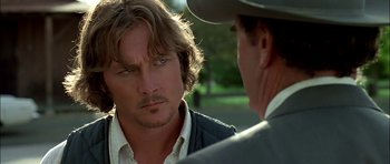 Movie still from “Fire in the Sky” (1993), directed by Robert Lieberman – Two men talking to each other in a park; Close Up shot, Over the shoulder angle
