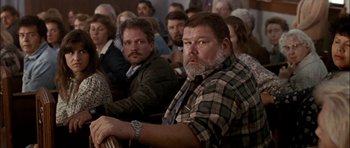 Movie still from “Fire in the Sky” (1993), directed by Robert Lieberman – A group of people sitting in a room; Medium shot, High angle