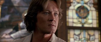 Movie still from “Fire in the Sky” (1993), directed by Robert Lieberman – A person with long hair; Close Up shot, Low angle