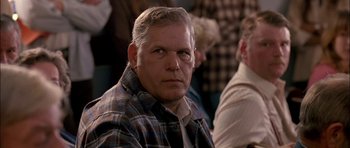 Movie still from “Fire in the Sky” (1993), directed by Robert Lieberman – A person wearing a plaid shirt; Close Up shot, Low angle
