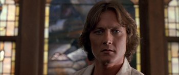 Movie still from “Fire in the Sky” (1993), directed by Robert Lieberman – A person with long hair; Close Up shot, Low angle