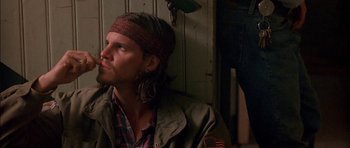 Movie still from “Fire in the Sky” (1993), directed by Robert Lieberman – A man with a bandana on his head; Close Up shot, Low angle