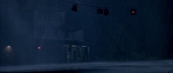 Movie still from “Fire in the Sky” (1993), directed by Robert Lieberman – A street scene with a building in the background; Extreme Wide shot, Low angle