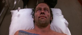 Movie still from “Fire in the Sky” (1993), directed by Robert Lieberman – A person laying in a bed; Close Up shot, Overhead angle