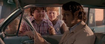 Movie still from “Fire in the Sky” (1993), directed by Robert Lieberman – A man looking at two boys in a car mirror; Close Up shot, Over the shoulder angle