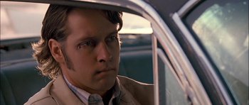 Movie still from “Fire in the Sky” (1993), directed by Robert Lieberman – A person sitting in a car; Close Up shot, Over the shoulder angle