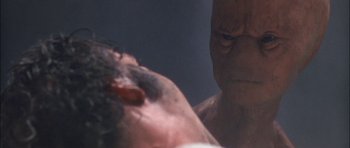 Movie still from “Fire in the Sky” (1993), directed by Robert Lieberman – A man's face as he stares at another man's face; Close Up shot, Over the shoulder angle