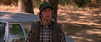 Movie still from “Fire in the Sky” (1993), directed by Robert Lieberman – A man wearing a green hat and a plaid shirt; Close Up shot, Low angle