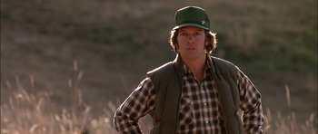 Movie still from “Fire in the Sky” (1993), directed by Robert Lieberman – A man wearing a green hat and a plaid shirt; Close Up shot, Low angle