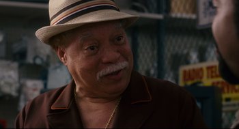 Movie still from “First Sunday” (2008), directed by David E. Talbert – An older man wearing a tan hat and a brown jacket; Close Up shot, Over the shoulder angle