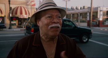 Movie still from “First Sunday” (2008), directed by David E. Talbert – An older man wearing a hat is talking to the camera; Close Up shot, Low angle